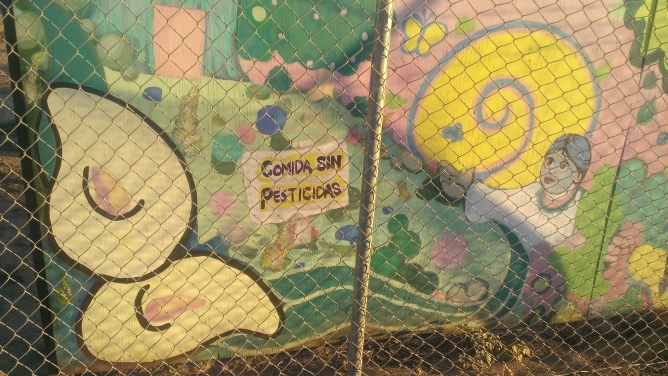 Youth in Plainview, CA created this mural, which in Spanish reads, \"Food without pesticides,\" when they were asked what kind of future they envisioned for a healthy food system and community. Image source: Ryan Van Lenning.